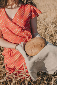 Homemade sourdough bread recipe. homemade artisan bread in woman hands on wheat field 