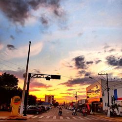 View of city street against cloudy sky