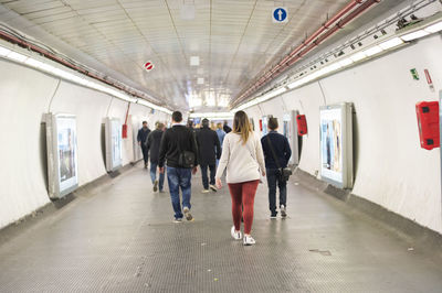 Rear view of people walking in corridor