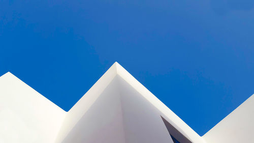 Low angle view of building against clear blue sky