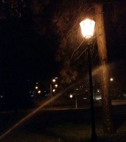 View of illuminated street lights at night