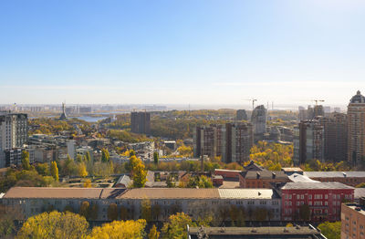 Buildings in city against clear sky