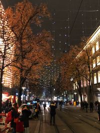 People walking on road in city at night