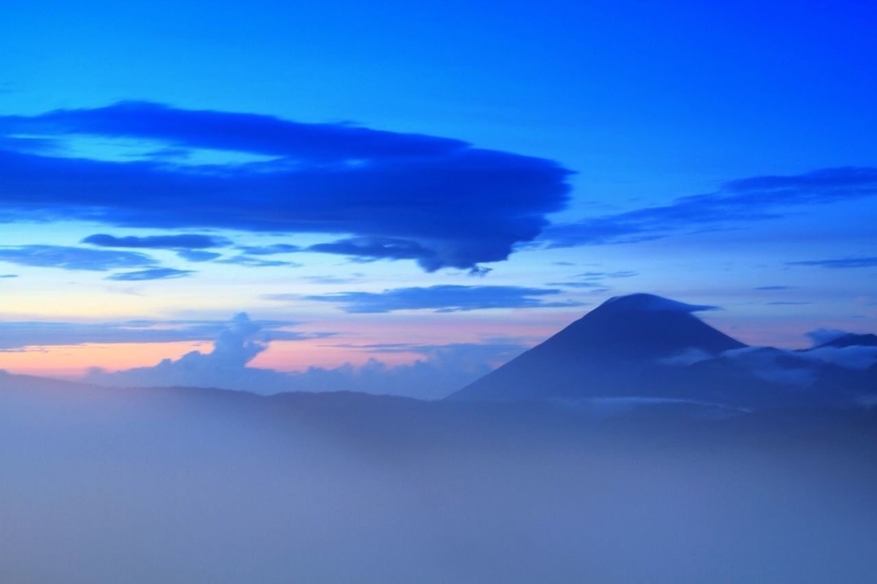 Scenic view of clouds over mountains