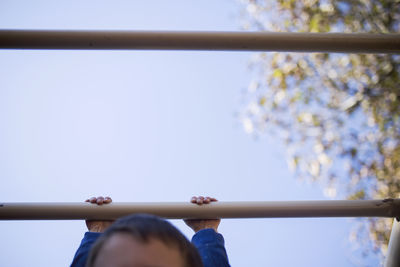 Low angle view of hands against sky