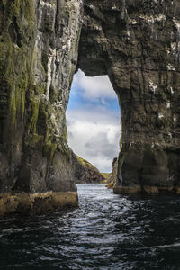 Scenic view of sea against sky through a rock formation