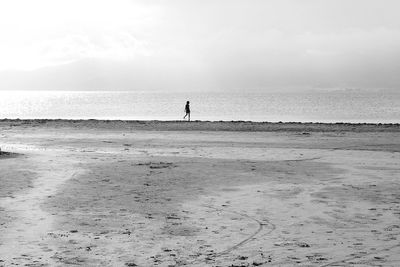 Man standing on beach against sky