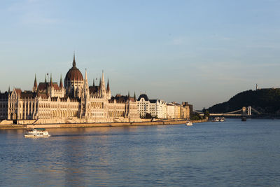 View of hungarian parliament building in budapest from the the river danube at sunset.