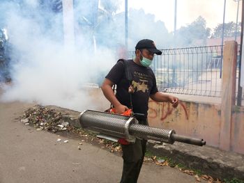 Man holding camera in city