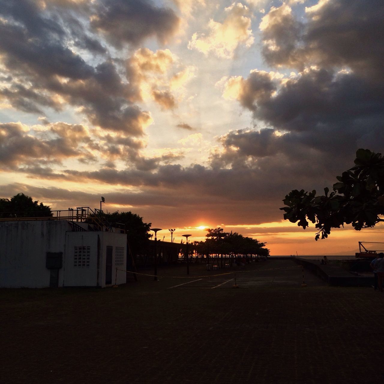 sunset, sky, sea, cloud - sky, beach, tranquility, tranquil scene, scenics, water, beauty in nature, horizon over water, built structure, silhouette, nature, tree, idyllic, shore, architecture, cloud, building exterior