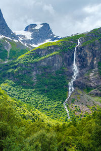 Norway landscape with big waterfall. waterfall in mountains of norway. tourism holidays and travel.
