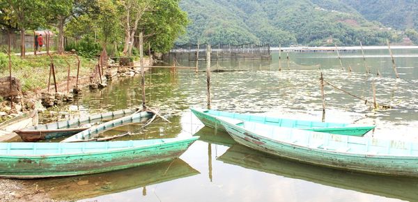 Boats moored in lake