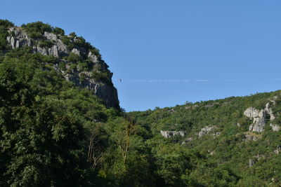 Scenic view of mountains against clear blue sky
