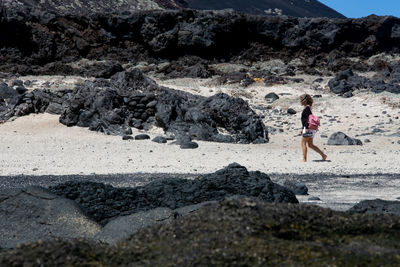 Woman standing on rock at beach