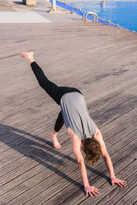 High angle view of man exercising on floorboard