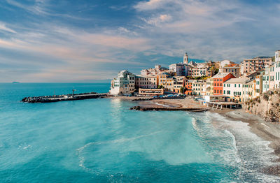 Scenic view of sea and buildings against sky