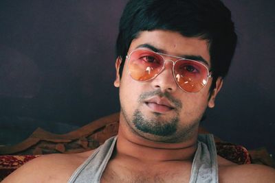 Close-up portrait of young man wearing sunglasses