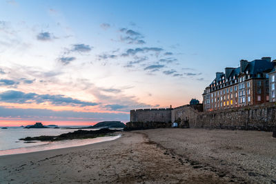 Scenic view of beach against sky during sunset