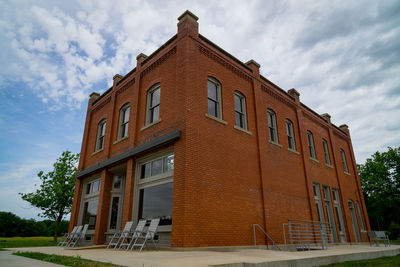 Low angle view of building against cloudy sky