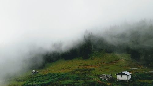 Scenic view of mountains in foggy weather