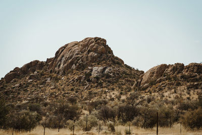 Rock formations on landscape against clear sky