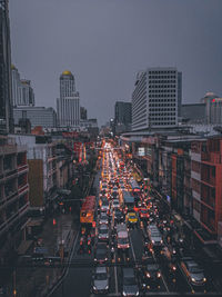 High angle view of traffic on city street amidst buildings