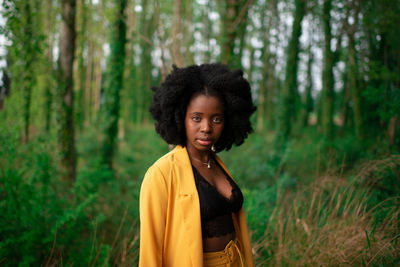 Portrait of woman standing in forest