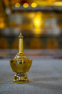Close-up of illuminated lamp on table in building
