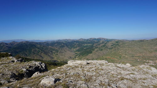 Scenic view of mountains against clear blue sky