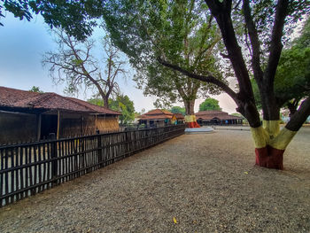 House amidst trees and buildings against sky