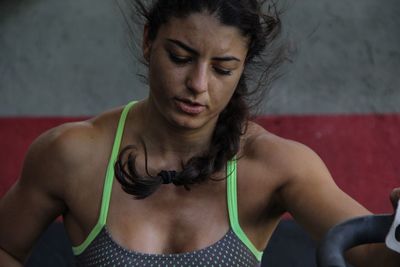 Close-up of young woman exercising at gym