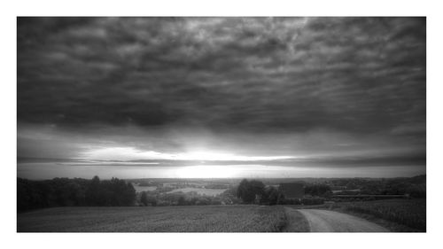 Scenic view of landscape against cloudy sky