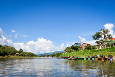 People in lake against sky