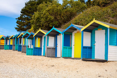 Row of beach huts on sand