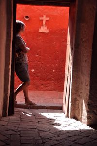 Full length of woman standing by railing