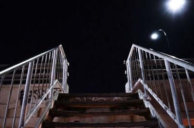 Low angle view of staircase against clear sky at night