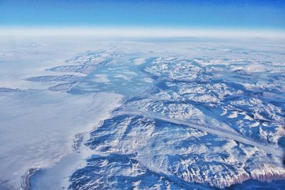 Aerial view of snowcapped mountains against sky