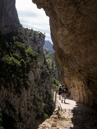 People walking on rock formation