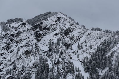 Low angle view of snow covered mountain against sky