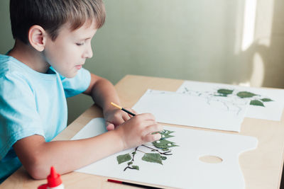 Boy drawing on paper