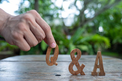 Close-up of hand holding ice cream on table