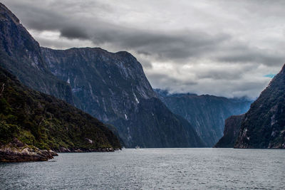 Scenic view of sea and mountains against sky