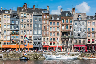 Boats in canal against buildings in city