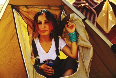 Portrait of woman sitting in tent