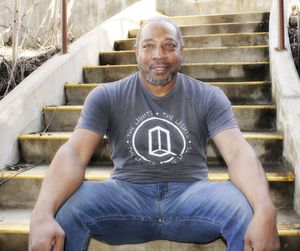 Portrait of young man sitting on staircase