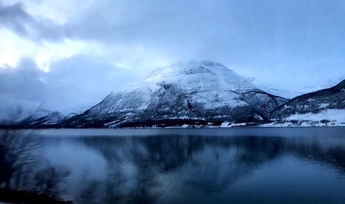 Scenic view of lake and mountains against sky