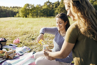 Smiling women having picnic