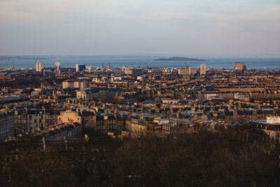 High angle view of townscape by sea against sky