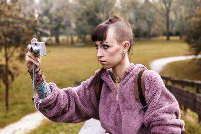 Portrait of woman photographing