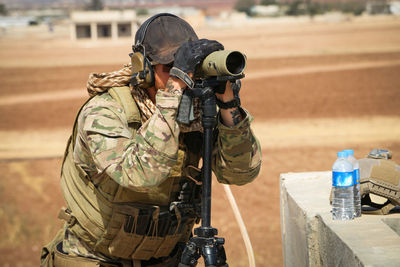 Midsection of man holding camera